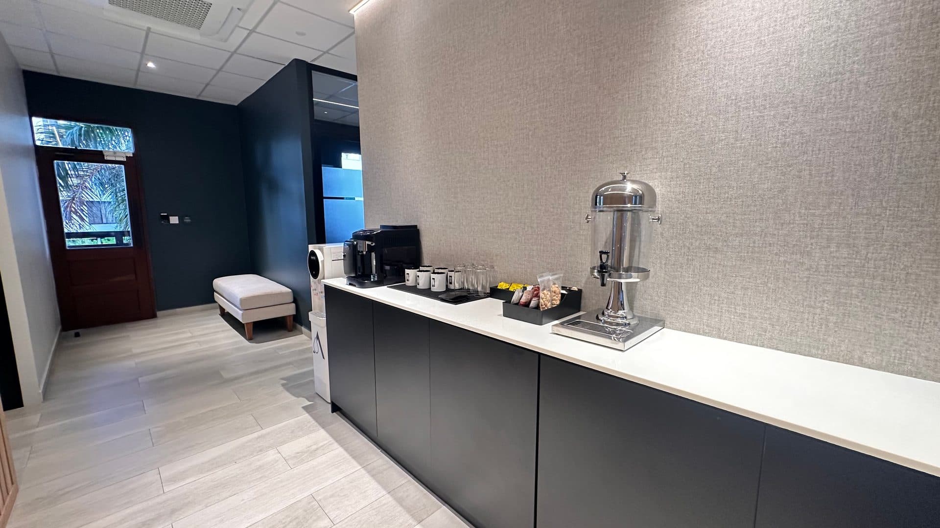 The kitchen at ZO Seacliff with a coffee machine and a door to the garden